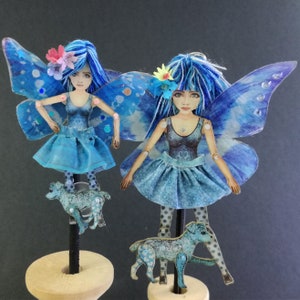 Fairy/Butterfly doll with a dog are articulated-a paper puppet. Art doll that is a jewelry.
