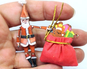 Tiny Santa Claus. Christmas time They have a pin on the back and are articuladed, a paper puppet, original art that can be a jewel