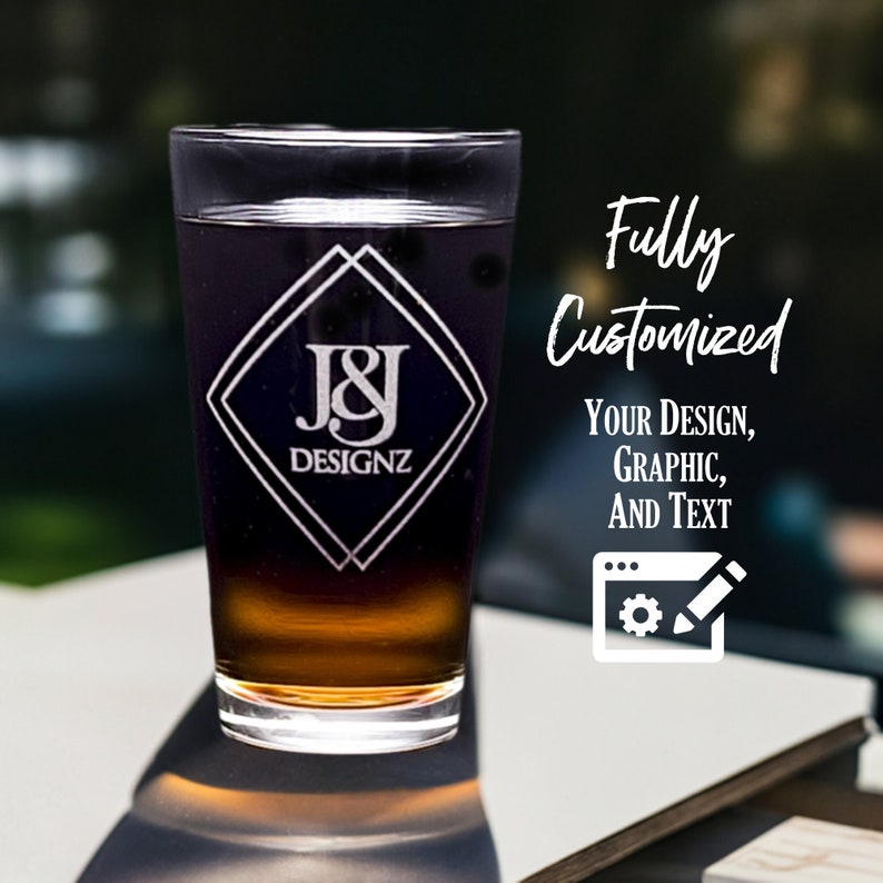 May include: A clear glass beer mug with a custom engraved design featuring the initials "J&J" and the text "DESIGNZ" in a diamond shape. The text "Fully Customized" appears above the mug, with the text "Your Design, Graphic, and Text" below. A white icon of a computer screen with a gear and pencil appears below the text.