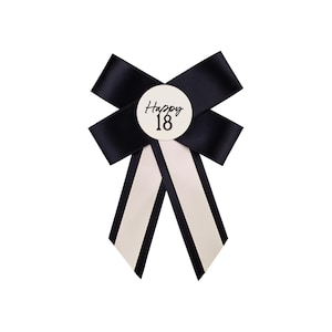 May include: Black and white bow with a white circle in the centre that says "Happy 18".