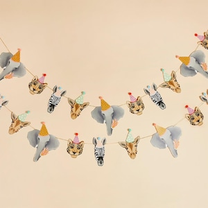 May include: A festive garland featuring animal heads, including elephants, zebras, giraffes, and leopards, each wearing a party hat. The garland is strung on a thin string against a light beige background.