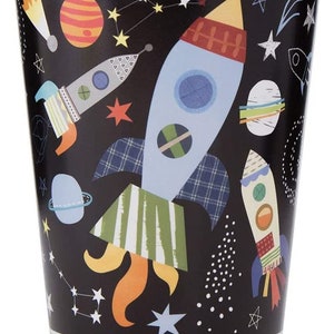 May include: Black paper cups with a space theme. The cups feature rockets, planets, and stars.
