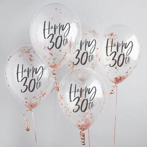 Puede incluir: Cinco globos transparentes llenos de confeti oro rosa. Cada globo tiene la frase "Happy 30th" en negro. Los globos est&aacute;n atados con cintas oro rosa, ideales para una fiesta de 30 cumplea&ntilde;os.