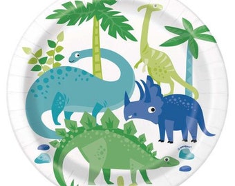 May include: A set of 8 white paper plates with a dinosaur theme. The plates feature a blue, green, and purple dinosaur with green palm trees and green leaves.