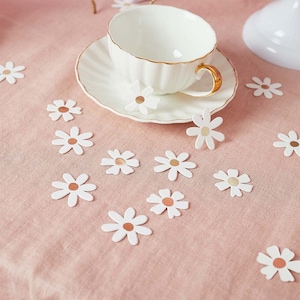 Confettis de table marguerites blanches pour un anniversaire groovy, un goûter dans le jardin