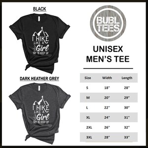 May include: Unisex t-shirt with a graphic of a hiker in front of mountains and the text "I hike like a girl try to keep up". The shirt is available in black and dark heather grey. Size chart with width and length measurements in inches.