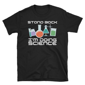 May include: Black t-shirt with a white graphic of beakers and flasks with the text "Stand Back I'm Doing Science".