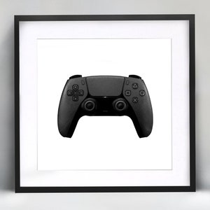 May include: A black video game controller with buttons and joysticks. The controller is in a black frame.