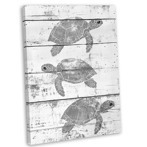 May include: A white wood background with three grey sea turtle silhouettes. The turtles are in different sizes and positions, creating a simple and elegant design.