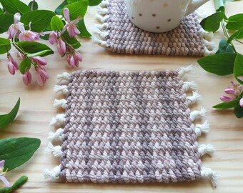 Set of two beige and brown handwoven coasters made of  hand-dyed cotton cord. Mug coasters for table decoration. Boho decor for dinning room