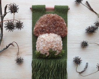 Mini woven wall hanging with fluffy mushroom.  Handmade, very small, narrow mushroom wall decor for forest themed room, bedroom, nursery.