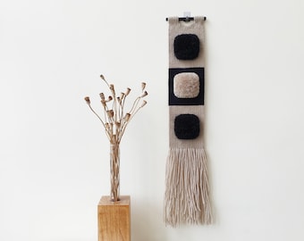 Small black and beige woven wall hanging. Narrow, vertical handwoven decoration. Small space boho wall decor for living room, hallway.