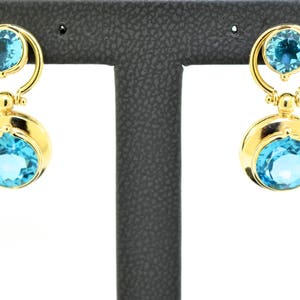 14k Yellow Gold And Blue Topaz Earrings.
