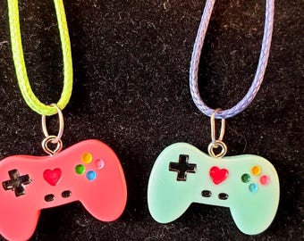 VIDEO GAME CONTROLLERS Set of 2 Charms Pendant Necklaces Free shipping! Blue charm on blue rope necklace; pink charm on lime green necklace.