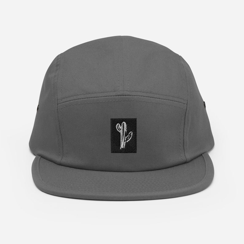 May include: A gray 5-panel cap with a black square patch featuring a white line drawing of a cactus.