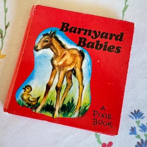 May include: A vintage children's book titled "Barnyard Babies" with a red cover. The cover features an illustration of a brown foal and a yellow duckling against a blue and green background. The book is labeled "A Pixie Book".