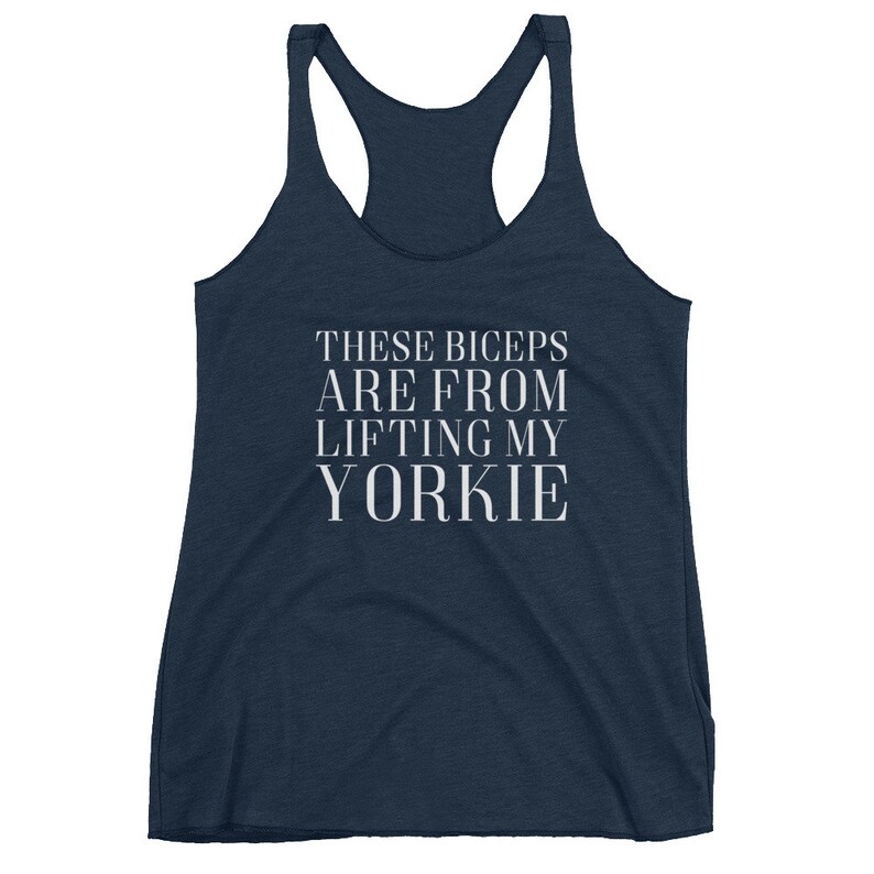 May include: A navy blue tank top with the text "These biceps are from lifting my yorkie" in white.