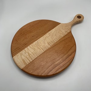 Handmade curly maple and cherry round cutting board with handle