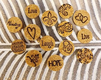 May include: A collection of 13 round cork coasters with various designs and words, including "Love", "Always", "Live", "Laugh", "Hope", and "XOXOXO".
