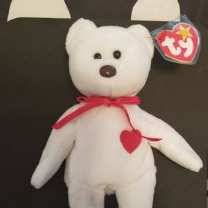 white beanie baby with red heart