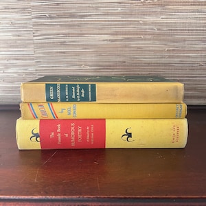 May include: A stack of four yellow and red paperback books with titles including "Cavalcade", "The Fireside Book of Humorous Poetry", "Green Mansions", and "Simon and Schuster".