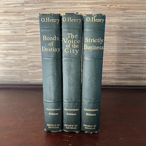 May include: Three vintage hardcover books by O. Henry. The books are titled "Roads of Destiny", "The Voice of the City", and "Strictly Business". Each book has an "Authorized Edition" label and a "Review of Reviews" label.