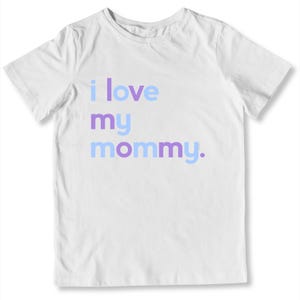 May include: White t-shirt with the phrase "i love my mommy" printed in light blue and purple. The shirt is a short-sleeved crew neck style, perfect for casual wear.