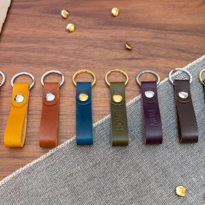 Slim Italian leather loop keyrings/keychains in multiple colours including black, brown, purple, olive green, navy blue, tan, yellow and red. Personalised with up to 6 letter debossed into the leather. Stainless steel or solid brass split ring and rivet.