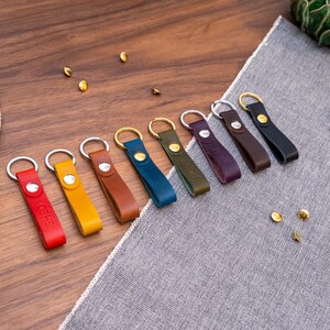 Slim Italian leather loop keyrings/keychains in multiple colours including black, brown, purple, olive green, navy blue, tan, yellow and red. Personalised with up to 6 letter debossed into the leather. Stainless steel or solid brass split ring and rivet.