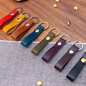 Slim Italian leather loop keyrings/keychains in multiple colours including black, brown, purple, olive green, navy blue, tan, yellow and red. Personalised with up to 6 letter debossed into the leather. Stainless steel or solid brass split ring and rivet.