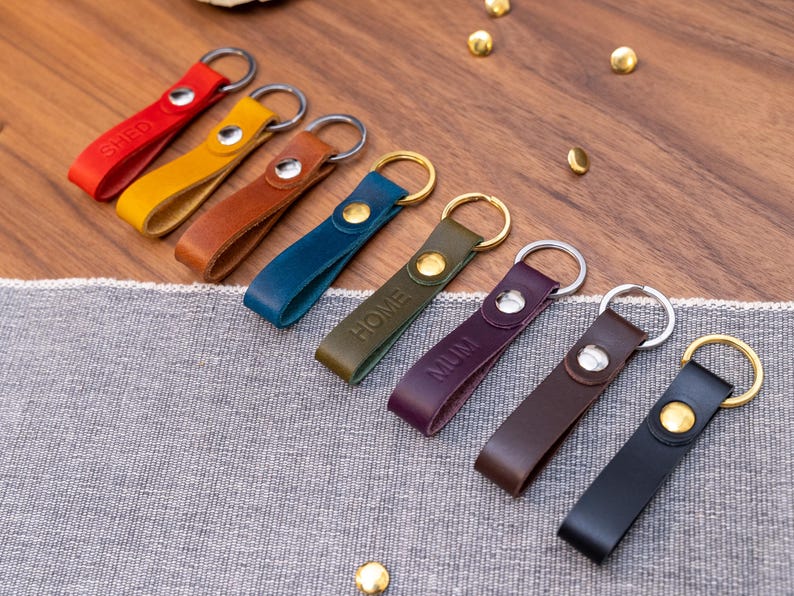 Slim Italian leather loop keyrings/keychains in multiple colours including black, brown, purple, olive green, navy blue, tan, yellow and red. Personalised with up to 6 letter debossed into the leather. Stainless steel or solid brass split ring and rivet.