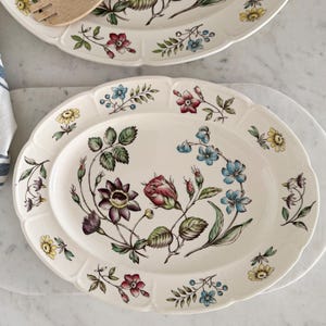 May include: A set of three ceramic mugs with a speckled, matte finish in cream, light grey, and dark grey. Each mug has a simple, minimalist design and a rounded handle.