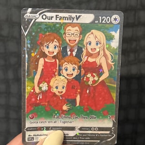 May include: A holographic trading card featuring a family illustration. The card reads "Our Family V" and includes the names Rob, Emma, Zoe, Theo, and Ollie. The family is depicted in a cartoon style, with the text "Gotta catch 'em all - Together!"