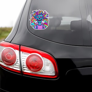 May include: A colorful sticker featuring a cartoon skull with rainbow hair and a pink and white striped shirt. The skull is surrounded by various colorful cartoon elements, including a rainbow, clouds, and stars.