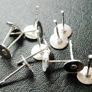 May include: Silver earring posts with round backs, perfect for making your own earrings.