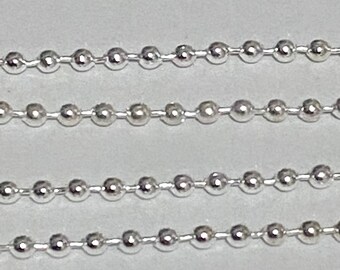 May include: A silver chain with small round links. The chain is made of metal and has a shiny finish.