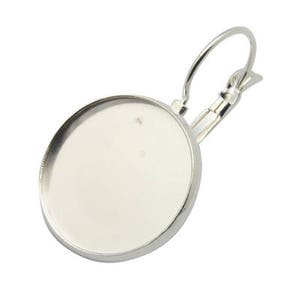 May include: A silver-colored earring component with a round bezel setting and a lever-back closure. The earring finding is designed for crafting custom jewelry pieces. The round setting is ready to be filled with a cabochon or other decorative element.