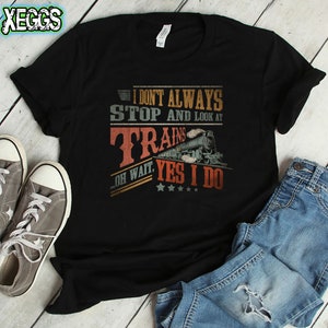 May include: Black t-shirt with a vintage-style graphic that reads "I don't always stop and look at trains. Oh wait, yes I do." The graphic features a train with a red, white, and blue color scheme.