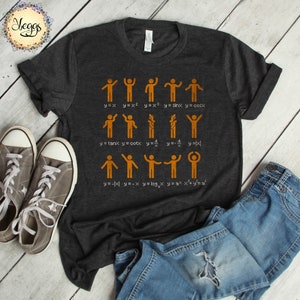 May include: Dark gray t-shirt with a graphic of stick figures representing mathematical functions. The shirt displays equations like y=x, y=x², and y=sinx. Gray sneakers and blue jeans are visible in the image.