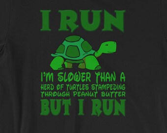 May include: Black t-shirt with a green turtle graphic and the text "I RUN I'M SLOWER THAN A HERD OF TURTLES STAMPEDING THROUGH PEANUT BUTTER BUT I RUN"