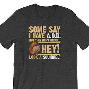 May include: Dark grey t-shirt with a squirrel graphic and the text "Some say I have A.D.D. But they don't under... HEY! Look a squirrel!"