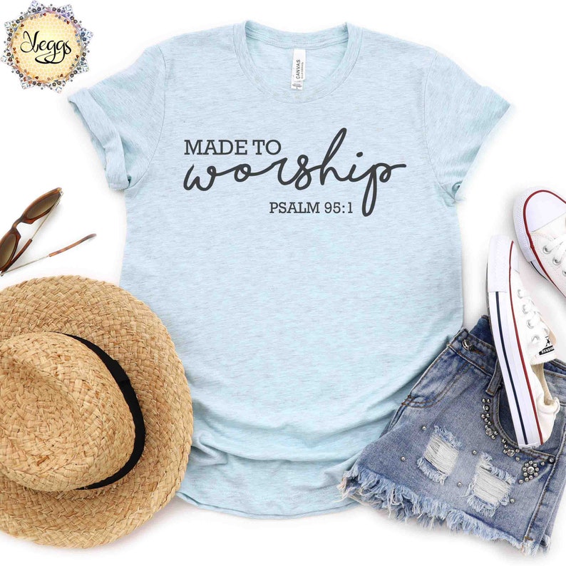 May include: Light blue t-shirt with the text "MADE TO worship" and "PSALM 95:1" in black lettering.
