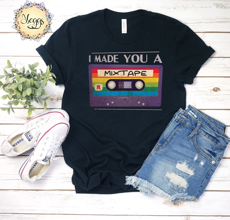 May include: A black t-shirt with the text "I made you a mixtape" and a vintage cassette tape graphic with rainbow colors.