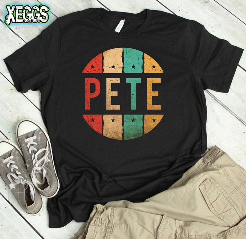 May include: Black t-shirt with a retro-style circular design featuring the name "PETE" in colorful block letters. The design has a distressed, vintage look.