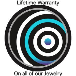 May include: A circular graphic featuring concentric rings in black, white, and cyan blue. The center is a solid blue dot. The text "Lifetime Warranty" appears above the circle, and "On all of our Jewelry" is printed below the graphic.