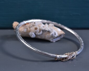 Sterling silver and 9ct gold thick band hammered bangle with bobbly gold loops and bands