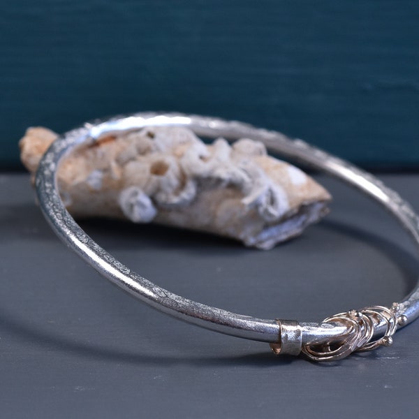 Sterling silver and 9ct gold thick band hammered bangle with bobbly gold loops and bands