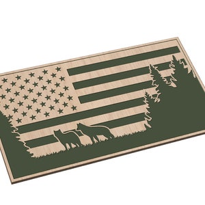 May include: Wooden sign with a cutout of the American flag, two wolves, and trees. The flag is in the center of the sign, with the wolves and trees on either side. The sign is painted in shades of green and brown.