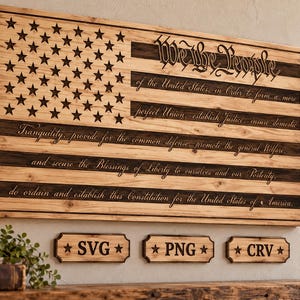 May include: A rectangular wooden wall sign featuring a laser-engraved American flag design. The text of the Preamble to the United States Constitution is etched across the stripes. Below, three small wooden plaques display the text SVG, PNG, and CRV.