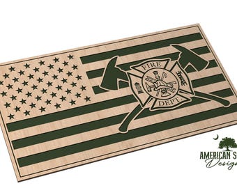 May include: A rectangular wooden wall art piece featuring a stylized American flag design with alternating light wood and dark green stripes. A central emblem displays two crossed axes behind a Maltese cross with the text FIRE DEPT.
